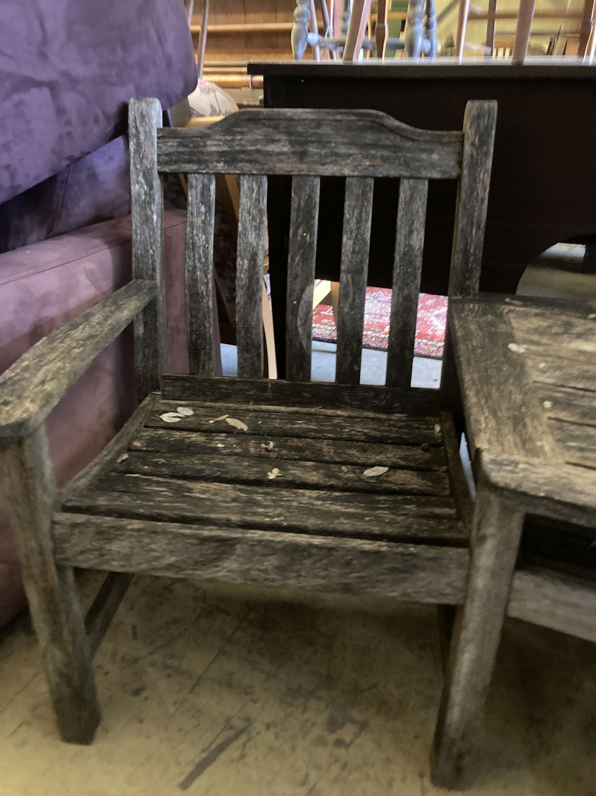 A weathered teak garden conversation seat, length 163cm, depth 80cm, height 86cm, together with a Gloster rectangular teak low garden t